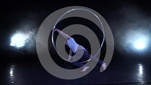 Circus artist dancing with cyr wheel. concept of concentration, willpower, and movement