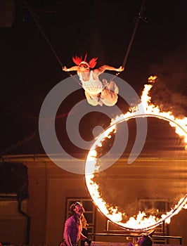 Circus artist flying through fire cicle