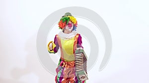 Circus clown dressed in funny colorful costume is enjoying her dance