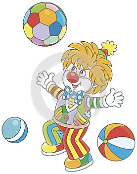 Funny clown playing with colorful balls