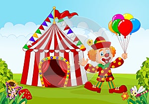 Circus tent with clown holding balloon in the green park