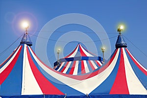 Circus tent under blue sky colorful stripes