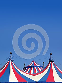 Circus tent under blue sky colorful stripes photo