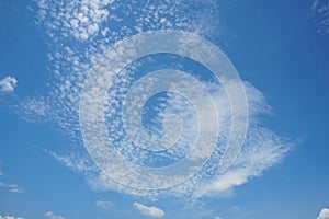 Cirrus clouds on the bright blue sky background.