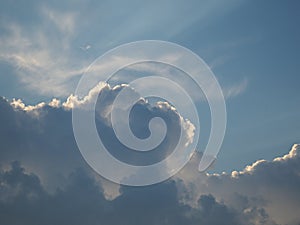 Cirrus, cumulus and nimbostratus clouds on a blue sky