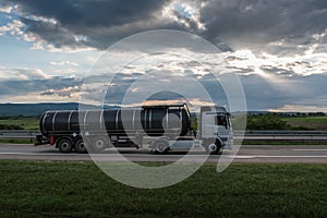 Cistern Tank truck on a sunset Highway road