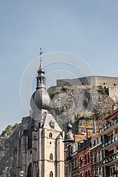 The Citadel towers high above the spire of Notre Dame Church, Dinant, Belgium