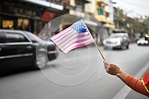 Citizen with flag welcomes diplomatic escort car passage