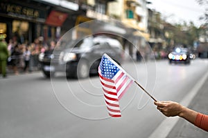 Citizen with flag welcomes diplomatic escort car passage