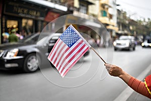 Citizen with flag welcomes diplomatic escort car passage