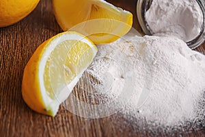 Citric acid on a wooden background with lemon. Selective focus