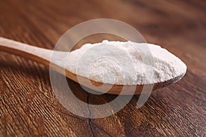 Citric acid on a wooden background with lemon. Selective focus