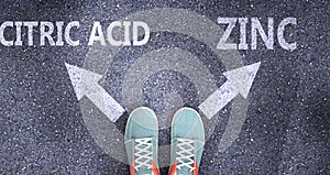 Citric acid and zinc as different choices in life - pictured as words Citric acid, zinc on a road to symbolize making decision and