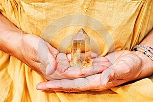 Citrine crystal holding by a woman