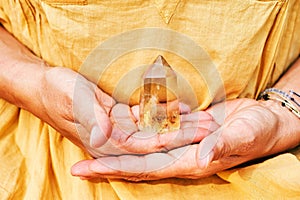 Citrine crystal holding by a woman photo