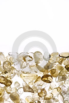 Citrine heap stones texture on half white light isolated background. Place for text