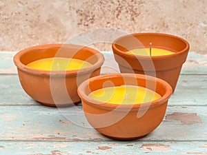 Citronella candle in a clay pot. A mosquito repellant for outdoor use