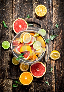 Citrus background. Fresh citrus fruits in the old bucket.