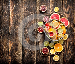 Citrus background. Fresh citrus fruits in the old bucket.