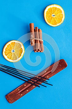 Citrus and cinnamon fragrance diffuser for air freshness on blue background top view