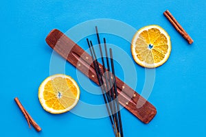 Citrus and cinnamon fragrance diffuser for air freshness on blue background top view