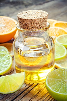 Citrus essential oil and slice of orange, lemon and lime fruits