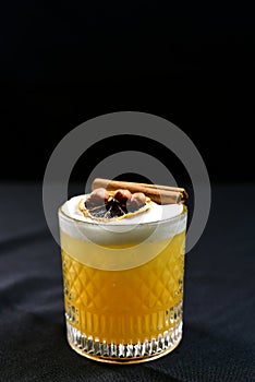 citrus fruit alcoholic iced drink fruit juice with cinnamon isolated on black background