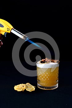 citrus fruit alcoholic iced drink fruit juice with cinnamon isolated on black background