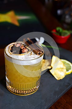 citrus fruit alcoholic iced drink fruit juice with cinnamon isolated on black background