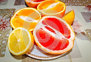 Citrus fruit cut in half on the table in a plate