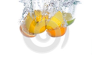 Citrus fruit falling in water