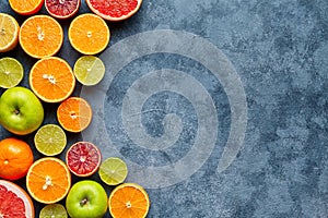 Citrus fruit mix on dark grey concrete table. Food background. Healthy eating. Antioxidant, detox, dieting, clean eating photo