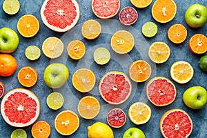 Citrus fruit pattern on grey concrete table. Food background. Healthy eating. Antioxidant, detox, dieting, clean eating photo