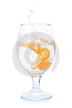 Citrus fruit slices into drinking glass isolated with clipping p