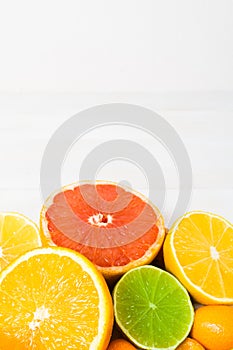 Citrus fruit on the white wooden background