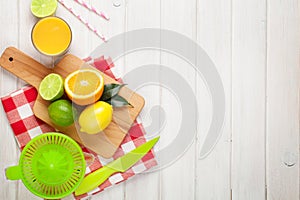 Citrus fruits and glass of juice. Oranges, limes and lemons