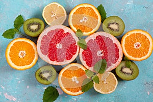 Citrus fruits with orange, lemon, grapefruit and lime on blue background