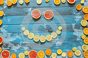 Citrus fruits. Oranges, limes and lemons. Over wooden table background with copy space