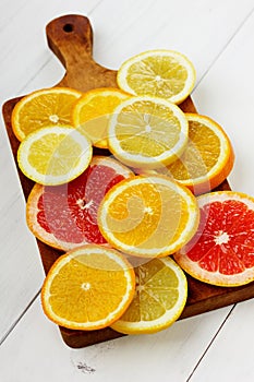 Citrus fruits slices on a brown wooden board