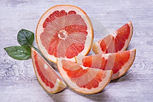 Citrus fruits slices of tropic grapefruits on a wooden background.