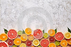 Citrus fruits vegan mix flat lay on white background, helthy vegetarian organic food