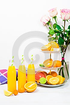 Citrus lemonade in the bottles with citrus ingredients on the ca