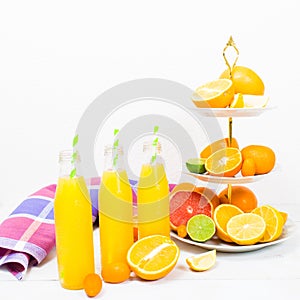 Citrus lemonade in the bottles with citrus ingredients on the ca