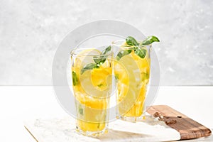 Citrus lemonade or mojito cocktail with lemon and orange and basil