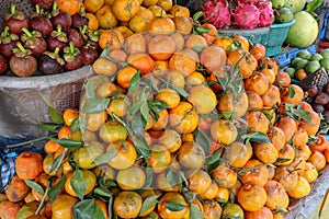 Citrus and tropical fruits on a traditional street market. Exhibited goods for sale. Stand with fresh and healthy fruit.