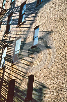City Apartment Building and Fire Escapes and Sunset - Reflection windows