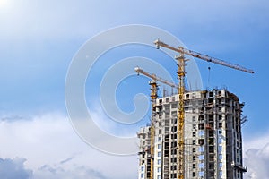 City background. Crane construction site on blue sky background. Industrial background. Construction building.
