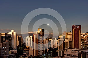 City of Belo Horizonte skyline with full moon over buildings