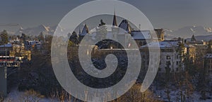 City of Bern seen from the Swiss parliament cliff on a cold winter with Bernisches Historisches Museum on sunset photo