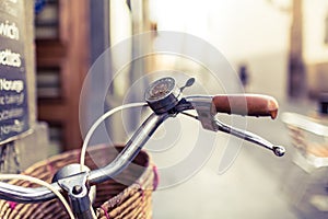 City bicycle handlebar and basket over blurred background